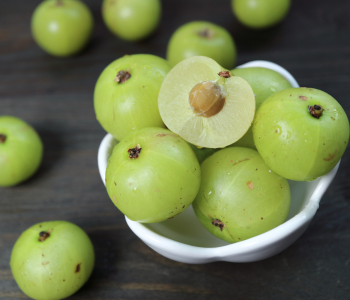 Sliced and whole organic amla in bowl, showcasing SoilSaga Naturals’ quality